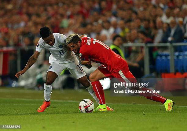 Raheem Sterling of England and Valon Behrami of Switzerland