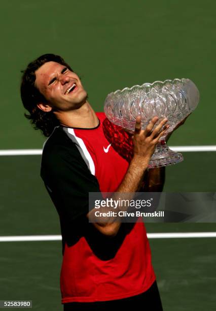 Roger Federer of Switzerland lifts the trophy after defeating Rafael Nadal of Spain in the men's final during the NASDAQ-100 Open at the Crandon Park...