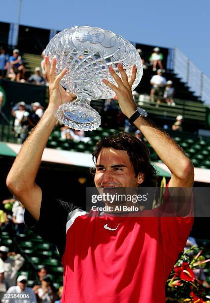 Roger Federer of Switzerland lifts the trophy after defeating Rafael Nadal of Spain in the men's final during the NASDAQ-100 Open at the Crandon Park...