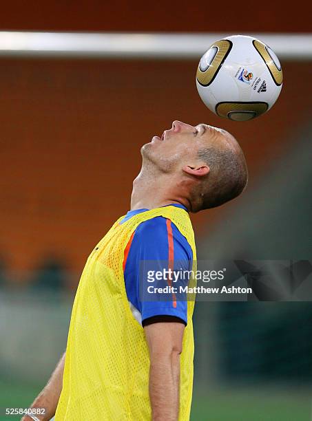 Arjen Robben of Netherlands rests the ball on his head during the training session ahead of the 2010 FIFA World Cup Final on Sunday