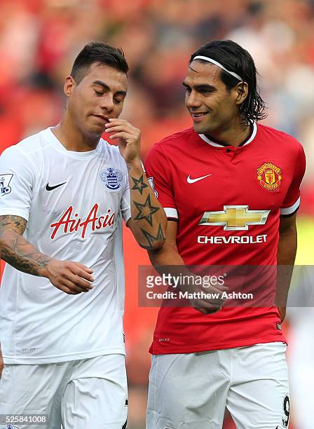 Eduardo Vargas of Queens Park Rangers walks off with Radamel Falcao of Manchester United at the end of the game