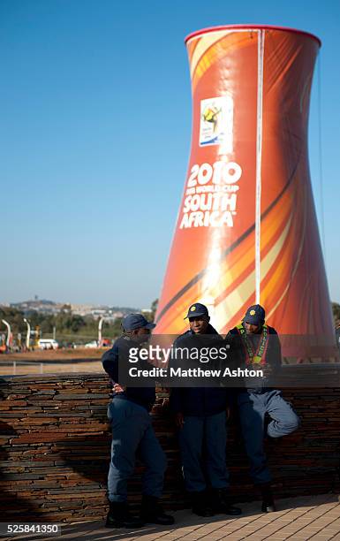 Police from Souht Africa in front of a cooling tower at Soccer City Stadium in Johannesburg