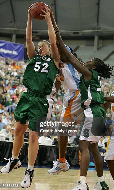 Liz Shimek of the Michigan State Spartans grabs a rebound over Shyra Ely of the Tennessee Lady Vols and Victoria Lucas-Perry of the Michigan State...