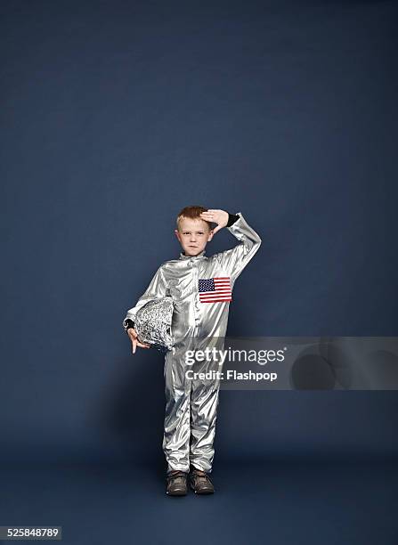 boy saluting, dressed as an astronaut - fancy dress costume stock pictures, royalty-free photos & images