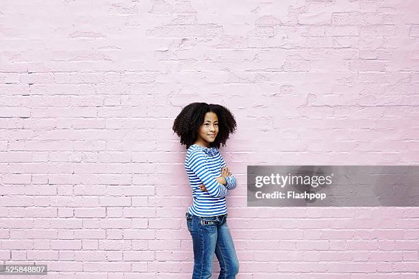 girl leaning against wall - children only photos ストックフォトと画像