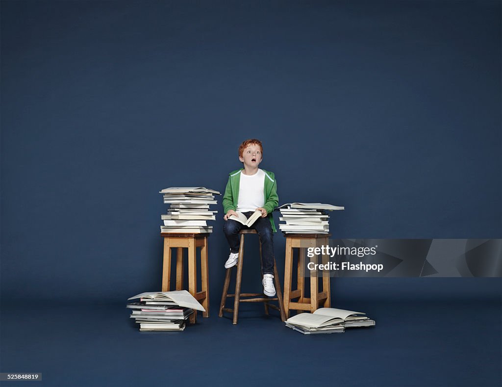 Boy with lots of books