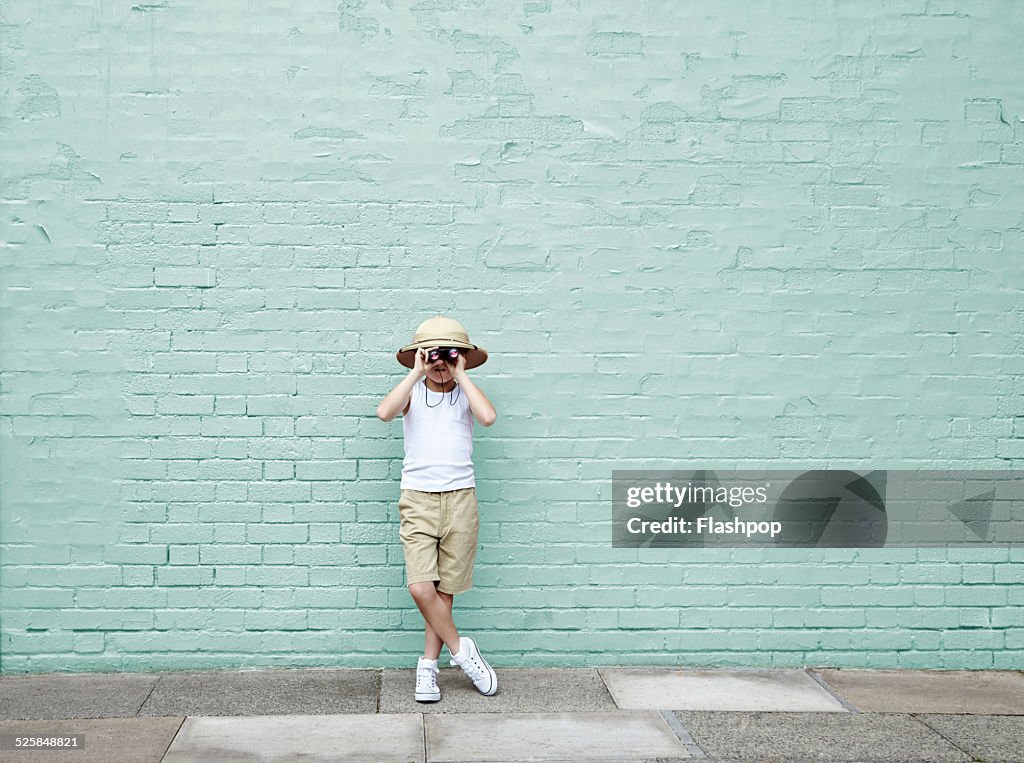 Boy dressed as an adventurer with binoculars