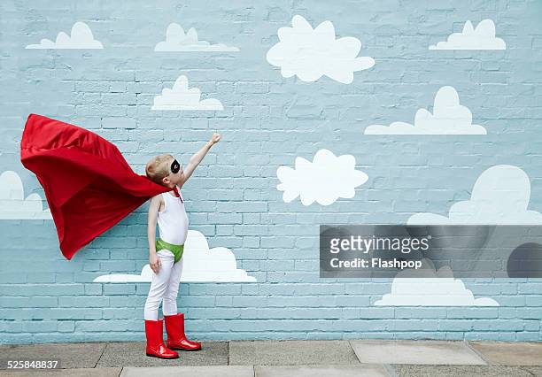 boy dressed as a superhero - erwartung stock-fotos und bilder