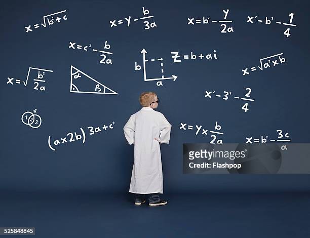 boy with mathematical equations - mathematical symbol stock pictures, royalty-free photos & images
