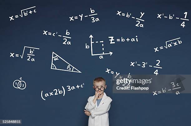 boy with mathematical equations - genius stock pictures, royalty-free photos & images