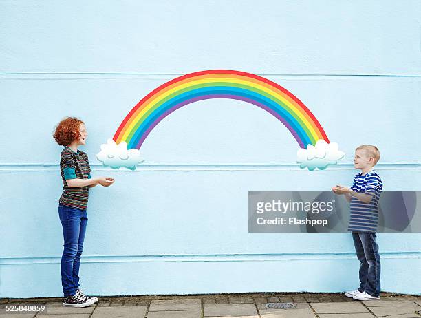 boy and girl holding cartoon rainbow - share ideas stock pictures, royalty-free photos & images