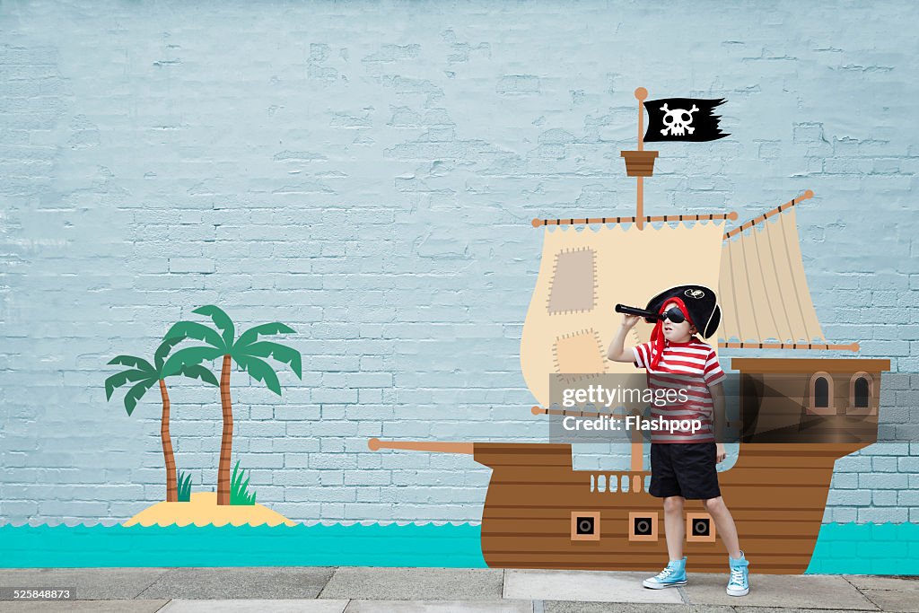 Boy dressed as a pirate with cartoon ship