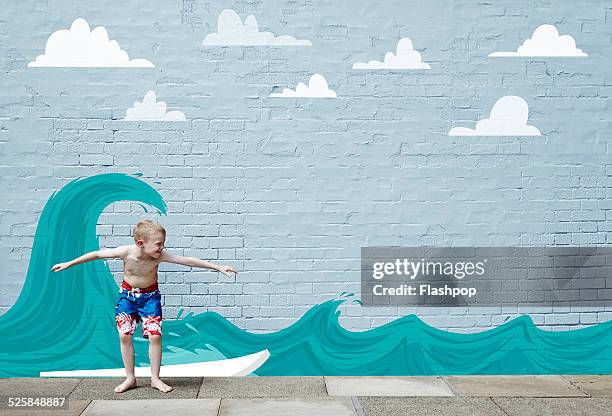 boy surfing on cartoon wave - surfer on wave cartoon stock pictures, royalty-free photos & images