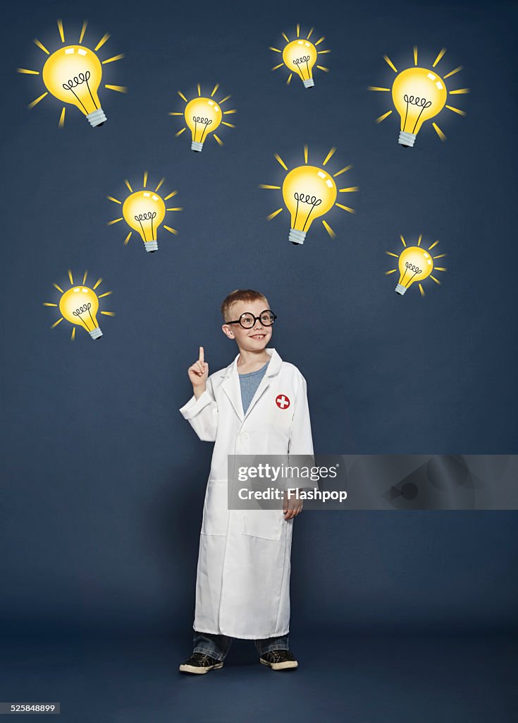 Boy in lab coat with cartoon lightbulbs