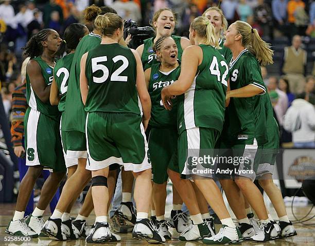 Kristin Haynie of the Michigan State Spartans celebrates with her teammates after defeating the Tennessee Lady Vols in the Semifinal game of the...