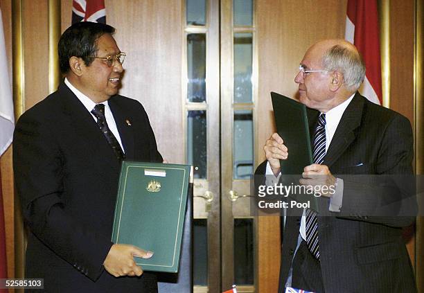 Australian Prime Minister John Howard and the President of Indonesia Susilo Bambang Yudhoyono sign an Australia Indonesia partnership agreement at...