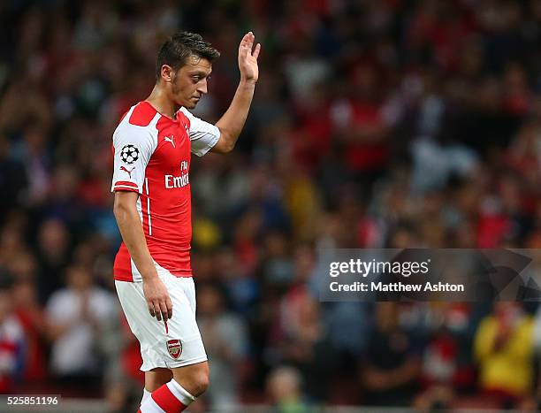 Mesut Ozil of Arsenal waves as he comes off as substitute