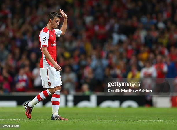 Mesut Ozil of Arsenal waves as he comes off as substitute