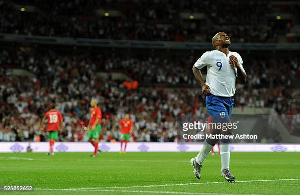 Jermaine Defoe of England in pain after scoring his hat trick to make it 4-0
