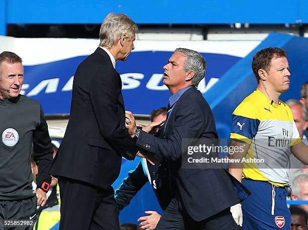 Arsene Wenger manager / head coach of Arsenal goes over to Jose Mourinho the head coach / manager of Chelsea and pushes him resulting in a scuffle...