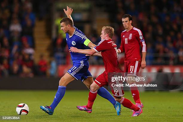 Edin Dzeko of Bosnia and Herzegovina and Jonathan Williams of Wales