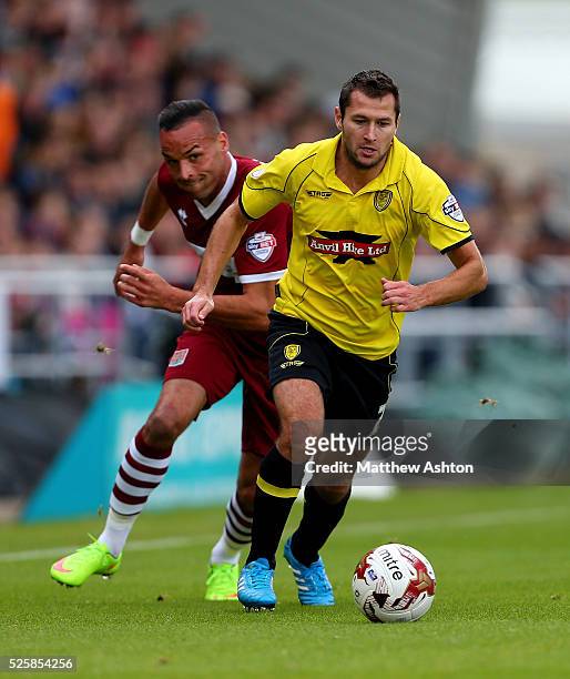 Phil Edwards of Burton Albion is chased down by Kaid Mohamed of Northampton Town