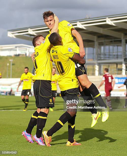 Jacob Blyth of Burton Albion is lifted aloft by his team mates as he plays down his celebration after scoring to make it 0-1, having previously...