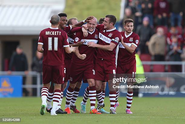 Ryan Cresswell of Northampton Town celebrates with his team mates after scoring to make it 1-1