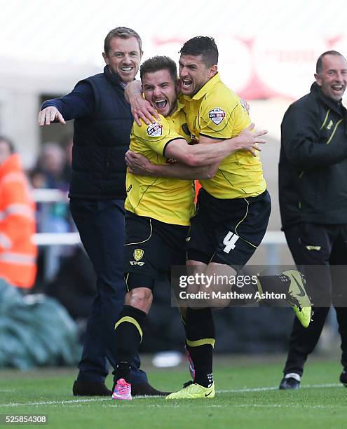 Alex MacDonald of Burton Albion runs past a jubilant Gary Rowett manager of Burton Albion as he celebrates after scoring a goal to make it 1-2 with...