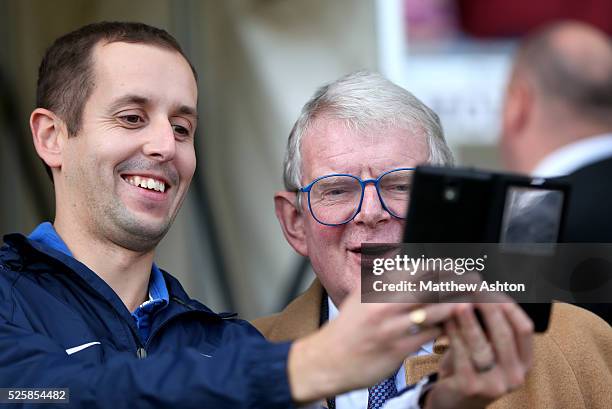 Football Commentator John Motson has his photo taken with a fan