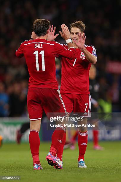 Gareth Bale of Wales celebrates the victory with Dave Edwards