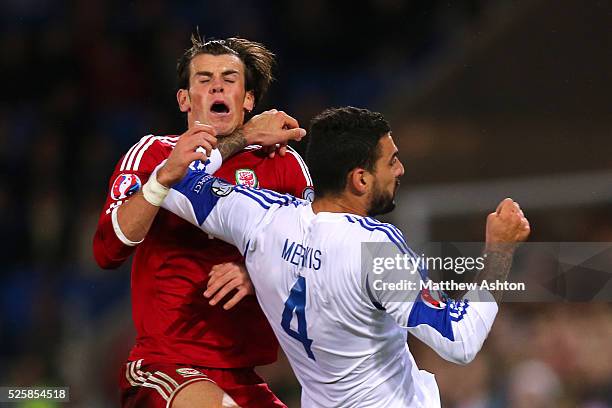 Giorgos Merkis of Cyprus fouls Gareth Bale of Wales