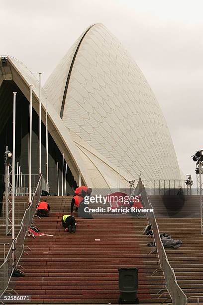 Workers install the red carpet on the steps of the Opera House before the World Premiere of Nicole Kidman latest movie "The Interpreter" at the Opera...