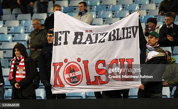 Fans FC Koln watch Lukas Podolski of Arsenal at Villa Park, home of Aston Villa