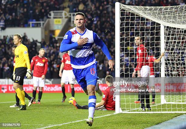 Dejected Manchester United players behind Sean Morrison of Reading as he celebrates after scoring a goal to make it 3-2