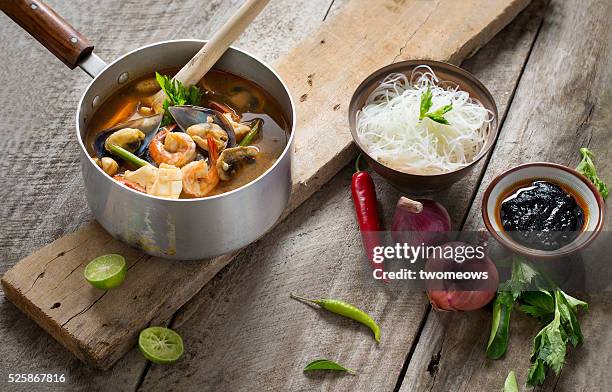 thai food spicy and sour seafood tom yam soup. - rustic dining room stock pictures, royalty-free photos & images