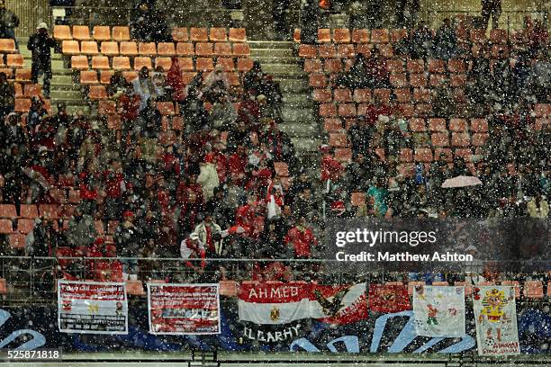 Snow falls in the Toyota Stadium in Toyota, Japan in front of freezing cold football supporters from Egypt, watching the representative of Africa, Al...