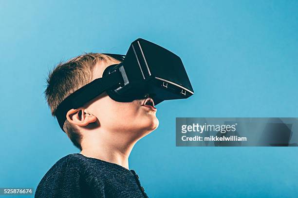 boy is surprised by content on vr glasses - graphic content stock pictures, royalty-free photos & images