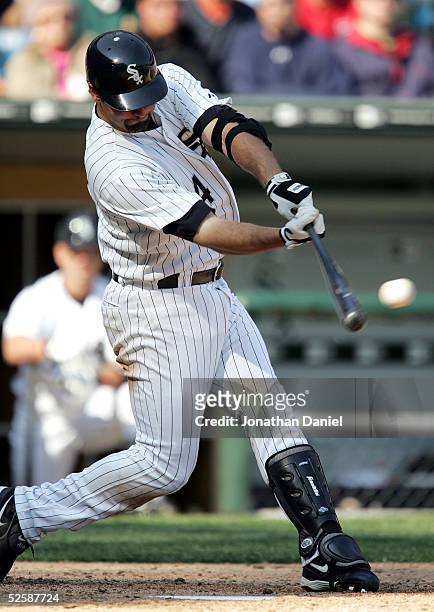 Paul Konerko of the Chicago White Sox hits a double in the seventh inning against the Cleveland Indians on April 4, 2005 at U.S. Cellular Field in...