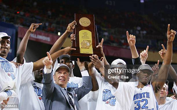 Head coach Roy Williams and the North Carolina Tar Heels celebrate with the trophy after defeating the Illinois Fighting Illini 75-70 to win the NCAA...