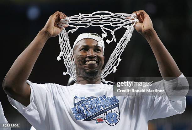 Jawad Williams of the North Carolina Tar Heels celebrates with one of the nets after defeating the Illinois Fighting Illini 75-70 during the NCAA...