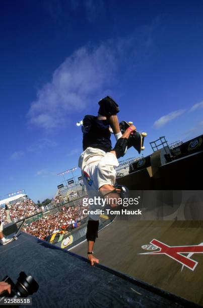 Tony Hawk catches air on the half pipe in the Skateboard Competition during the 1998 X Games on June 24, 1998 in San Diego, California.