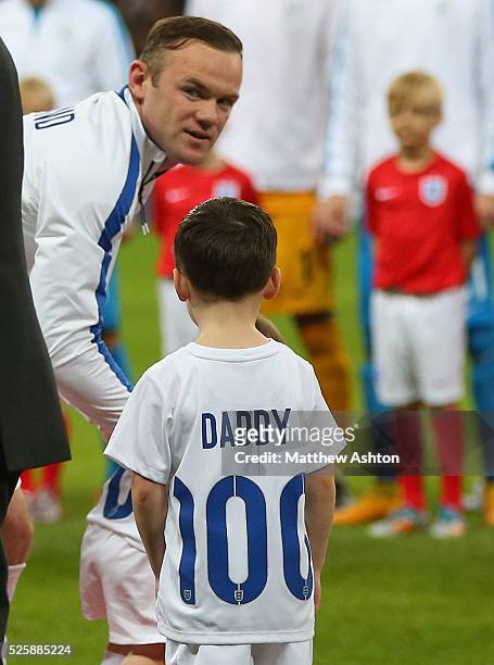 Wayne Rooney of England with his son Kai who is wearing a daddy 100 shirt to mark the 100th appearance
