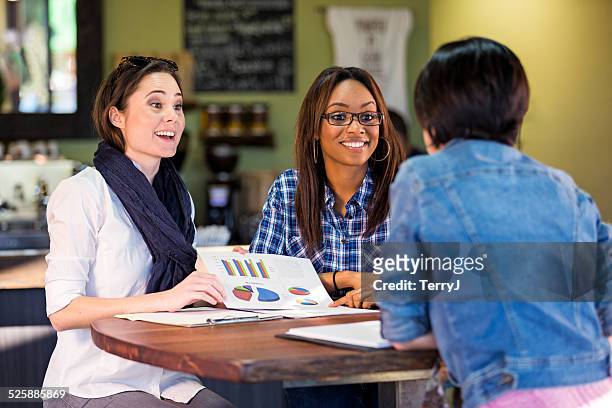 two women making a presentation to a potention client - business pitch stock pictures, royalty-free photos & images