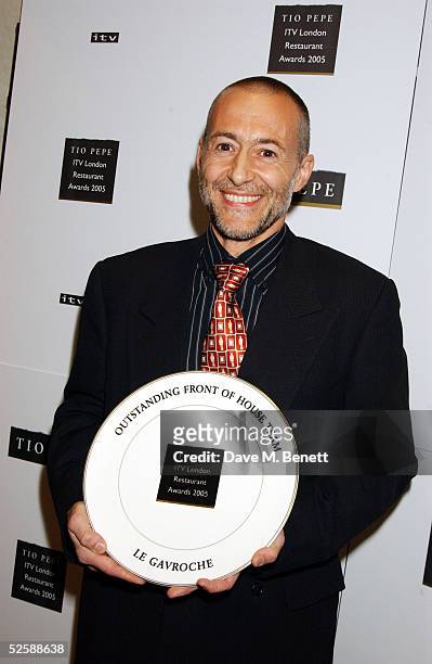 Michel Roux poses with the award for Outstanding Front of House Team at The Tio Pepe/Carlton London Restaurant Awards 2005 at the Grosvenor House...