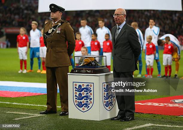 Sir Bobby Charlton stands next to the cap which was presented to Wayne Rooney of England to mark his 100th appearance