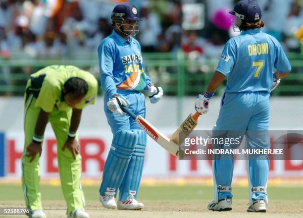 Indian cricketer Virender Sehwag congratulates teammate Mahender Dhoni after the latter hit a boundary off Pakistani bowler Rana Naved-ul-Hassan...