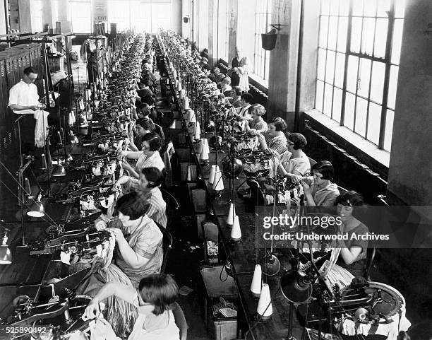 Scene in a women's silk hosiery factory, Philadelphia, Pennsylvania, circa 1922. The women are working on the seaming machines which sew the seam up...