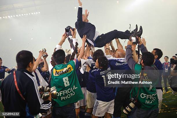 Alberto Zaccheroni the head coach / manager of Japan gets thrown into the air as his team celebrate after winning the Asian Cup 2011