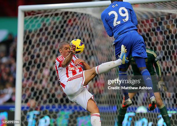 Jonathan Walters of Stoke City gets the ball in his face from Demba Ba of Chelsea